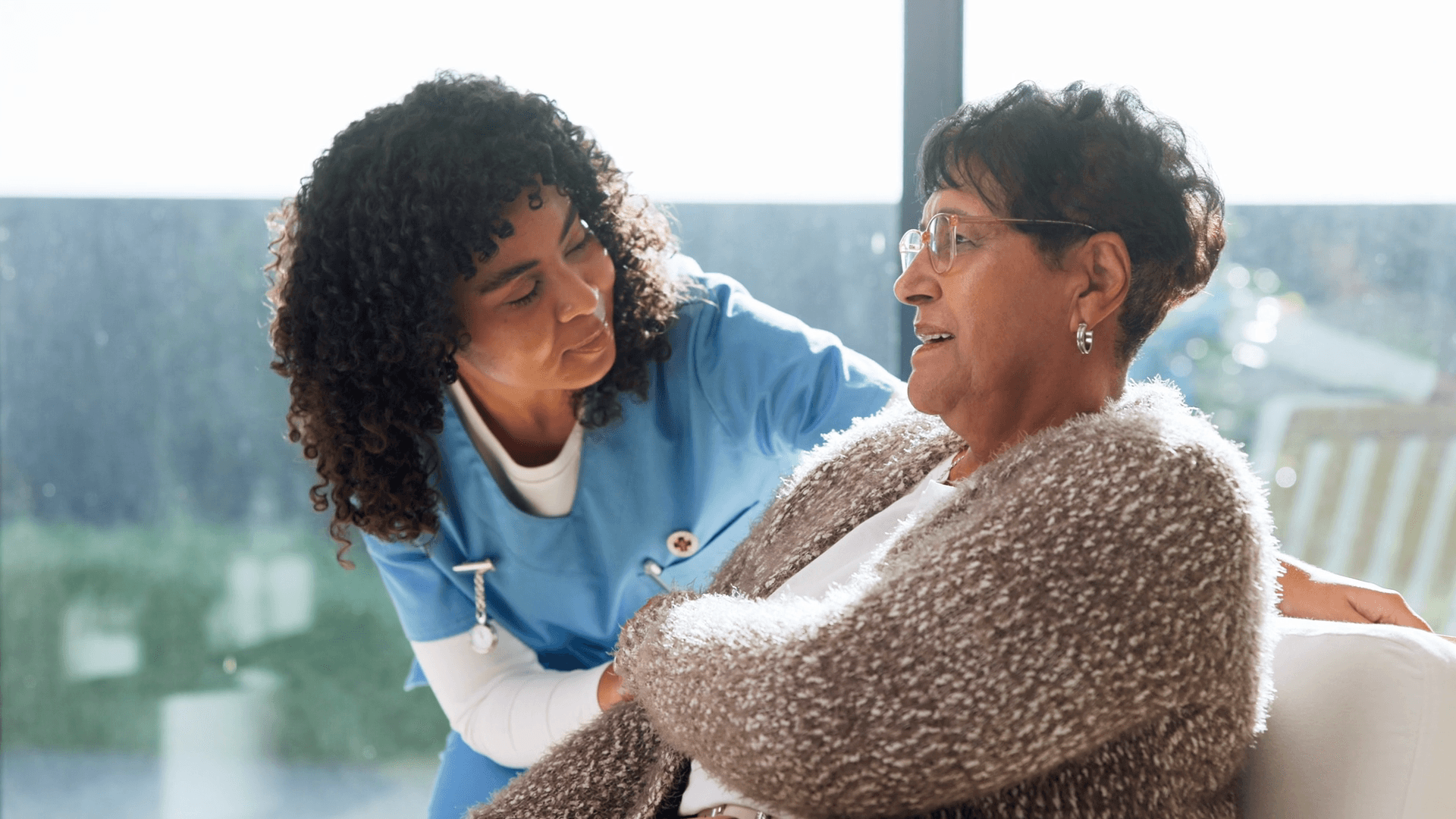A carer helping a resident in a care home
